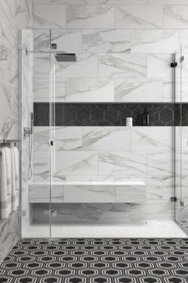 geometric black tile floor in bathroom with marble shower